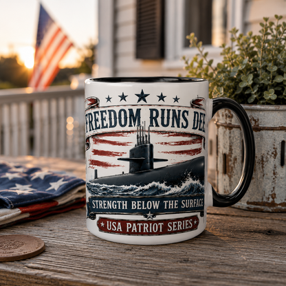 Mug with submarine design and text on a wooden surface with an American flag and plant in the background.